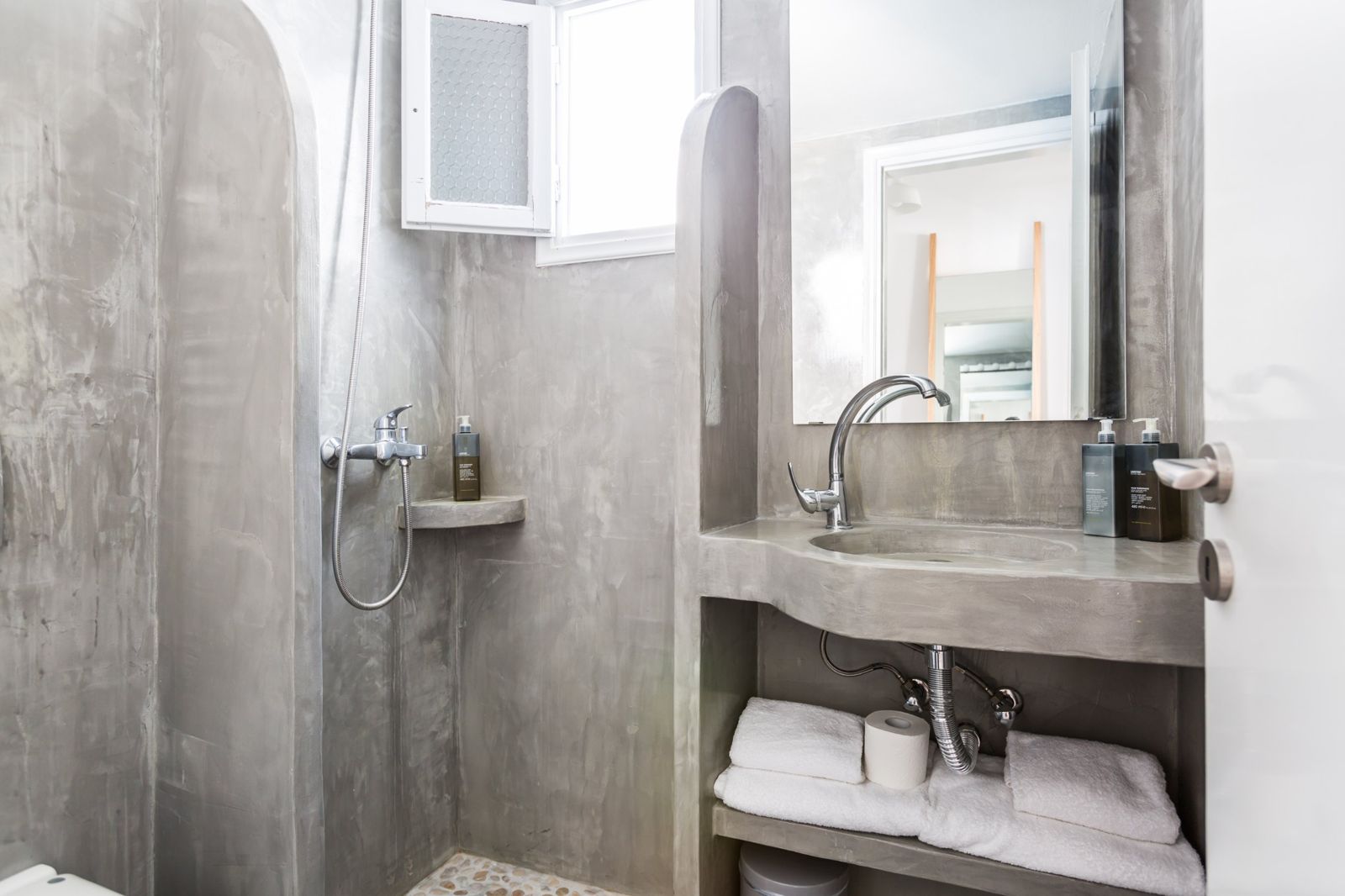 Microcement bathroom with pebble-floor shower