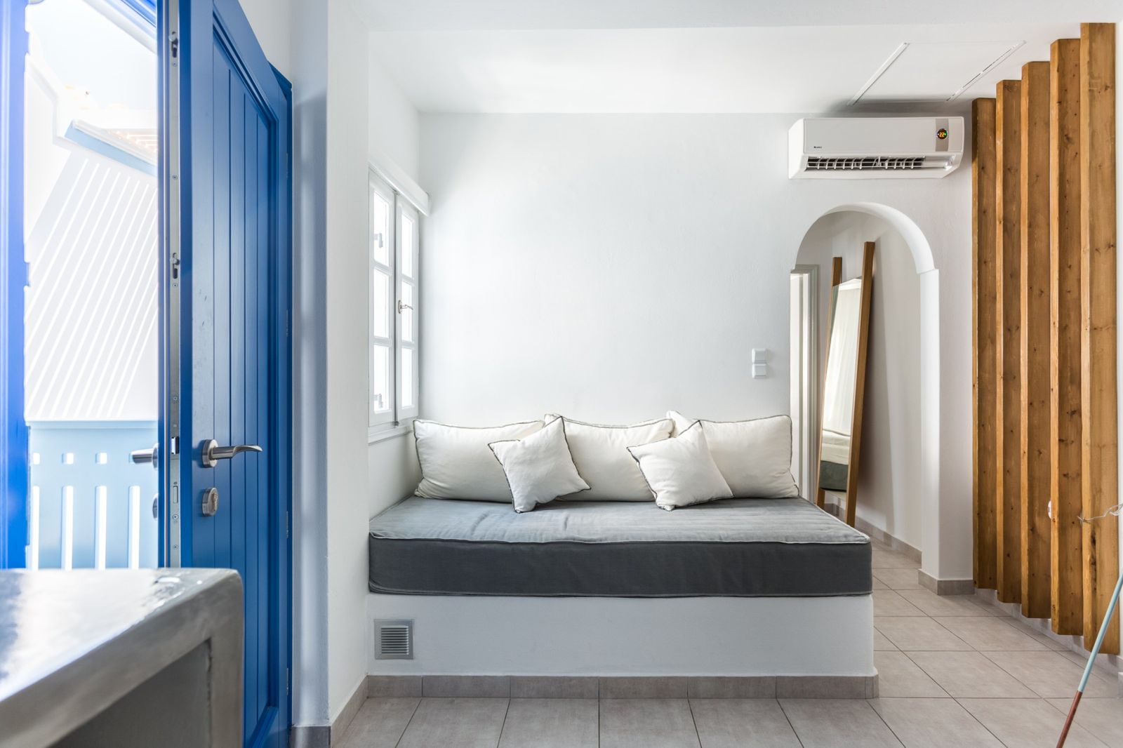 Living area with built-in daybed and arched doorway